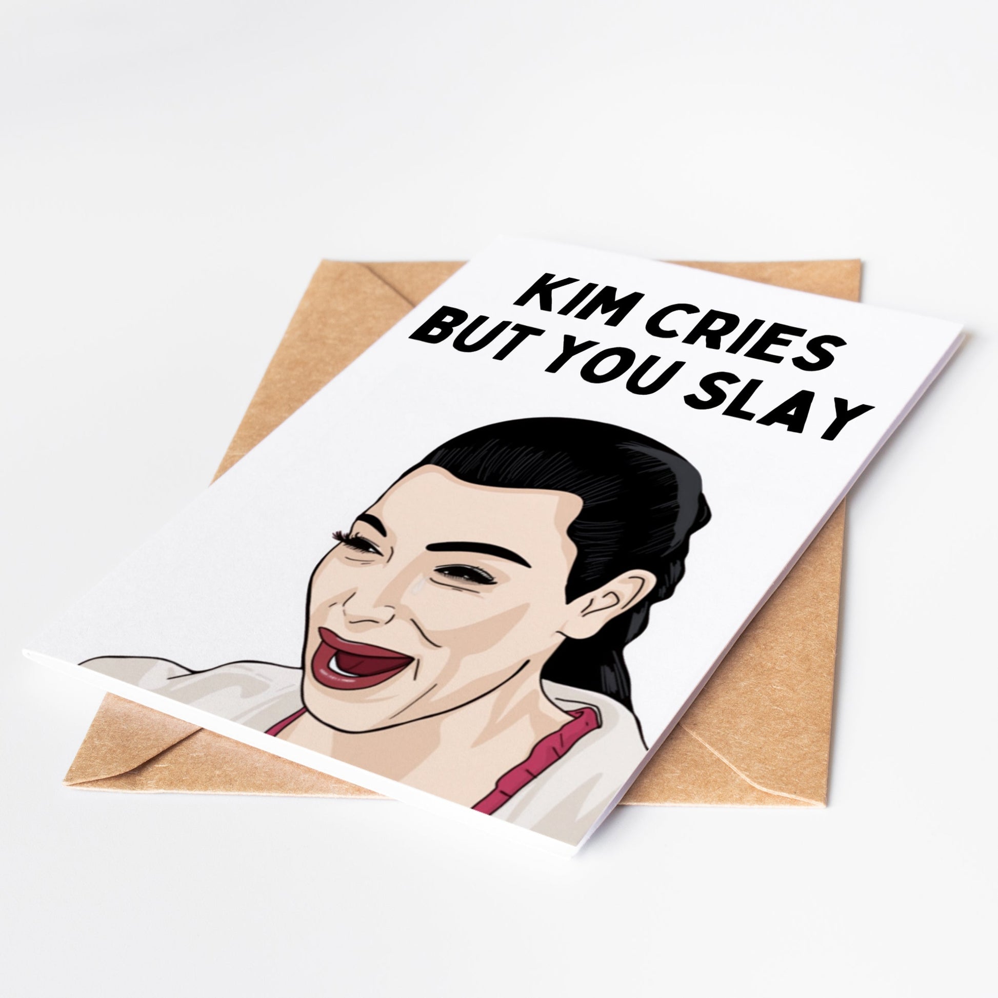 Impress your friends with this hilarious Kim Kardashian greeting card featuring a funny picture of Kim crying, with the message "Kim cries but you slay". Show off your sense of humor and make someone's day with this one-of-a-kind card.
